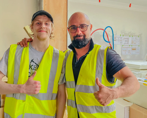 Two team members giving thumbs up