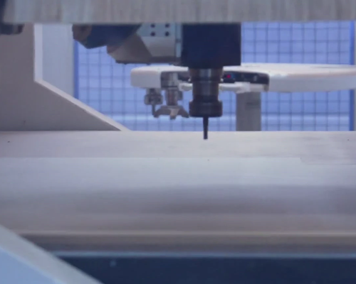 CNC machine cutting a timber window component
